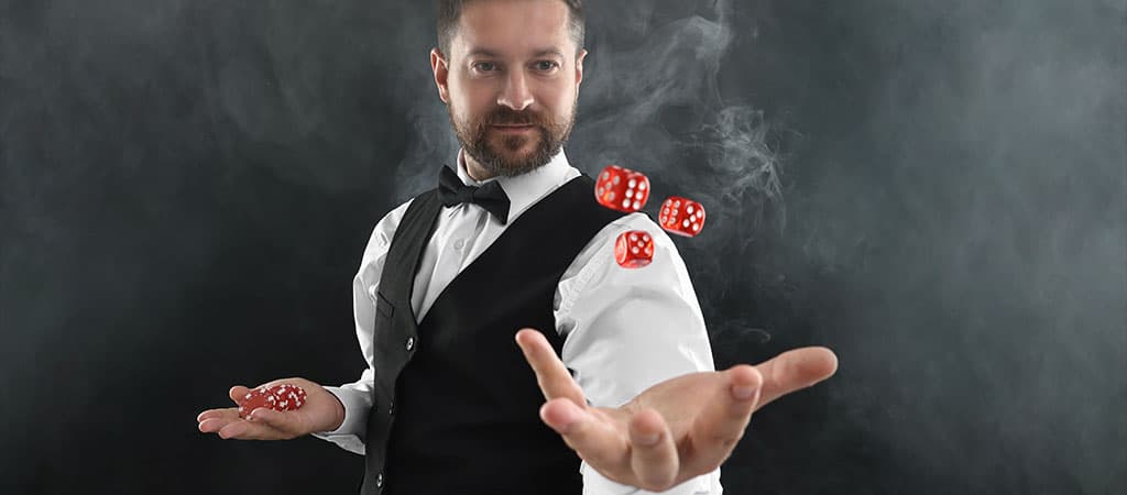 Elegánsan öltözött férfi, aki zsetonokat és dobókockákat dob a levegőbe, szerencsejáték és stratégia témában.